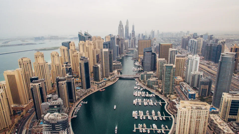 The Dubai Marina and Jumeirah Beach Residences (L) are seen from above on February 8, 2017 in Dubai, United Arab Emirates.